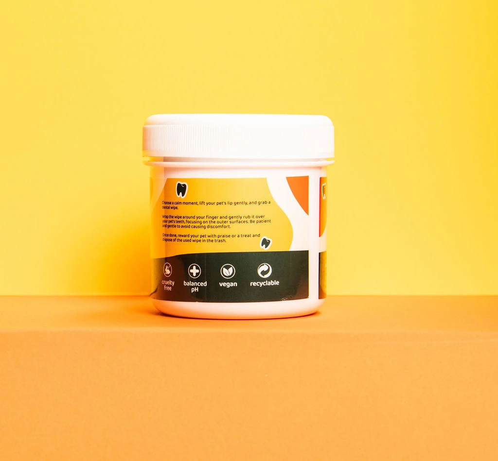 Pa & Paws Pet Dental Finger Wipes tub, studio photography on a yellow-to-orange gradient background.