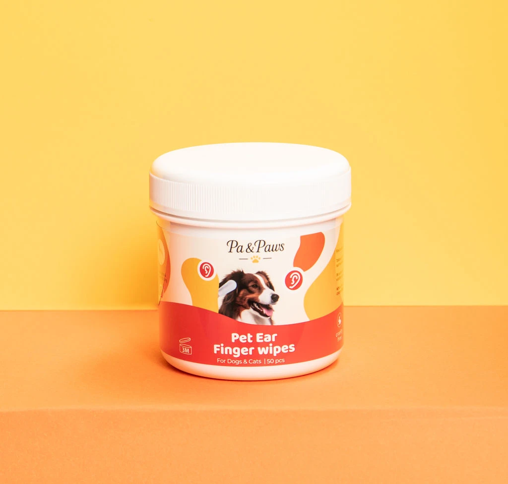 Pa & Paws Pet Ear Finger Wipes tub, studio photography on a yellow-to-orange gradient background.