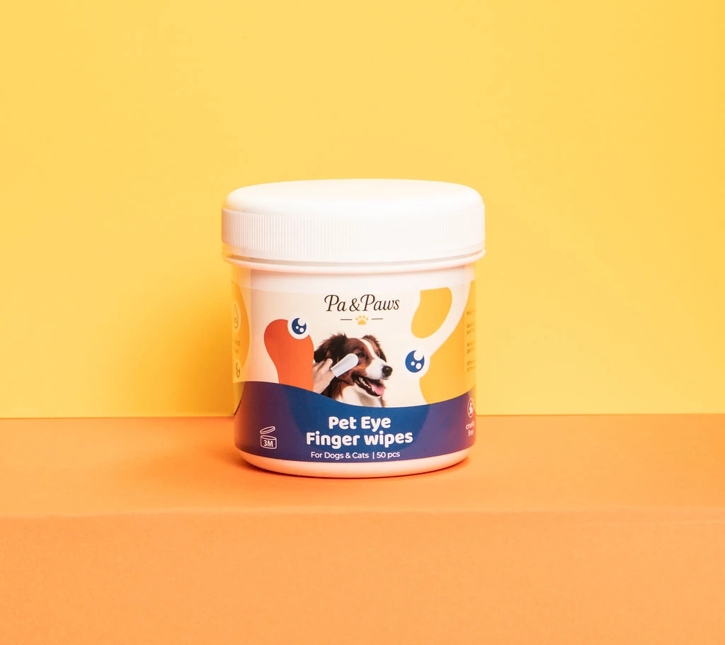 Pa & Paws Pet Eye Finger Wipes tub, studio photography on a yellow-to-orange gradient background.